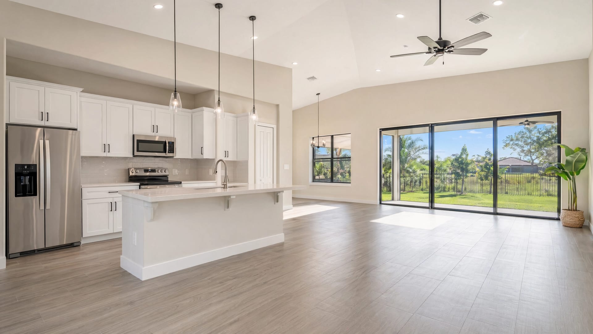 Bright open-concept kitchen and living room in a new Lehigh Acres home